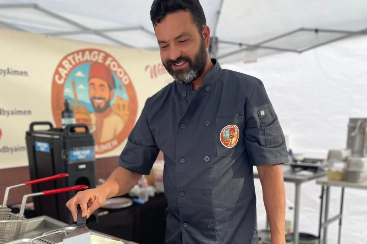 A Carthage Kitchen chef cooking to order at a live station