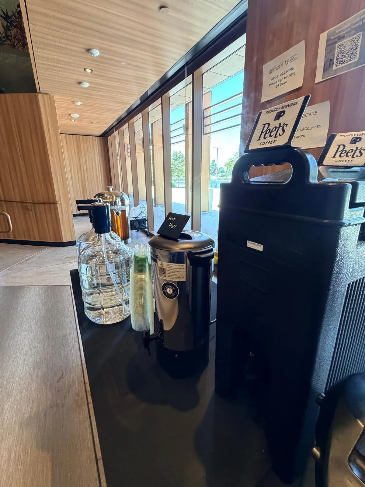 Commercial beverage station proudly serving Peet's coffee, hot water urn, and iced hydration carafes