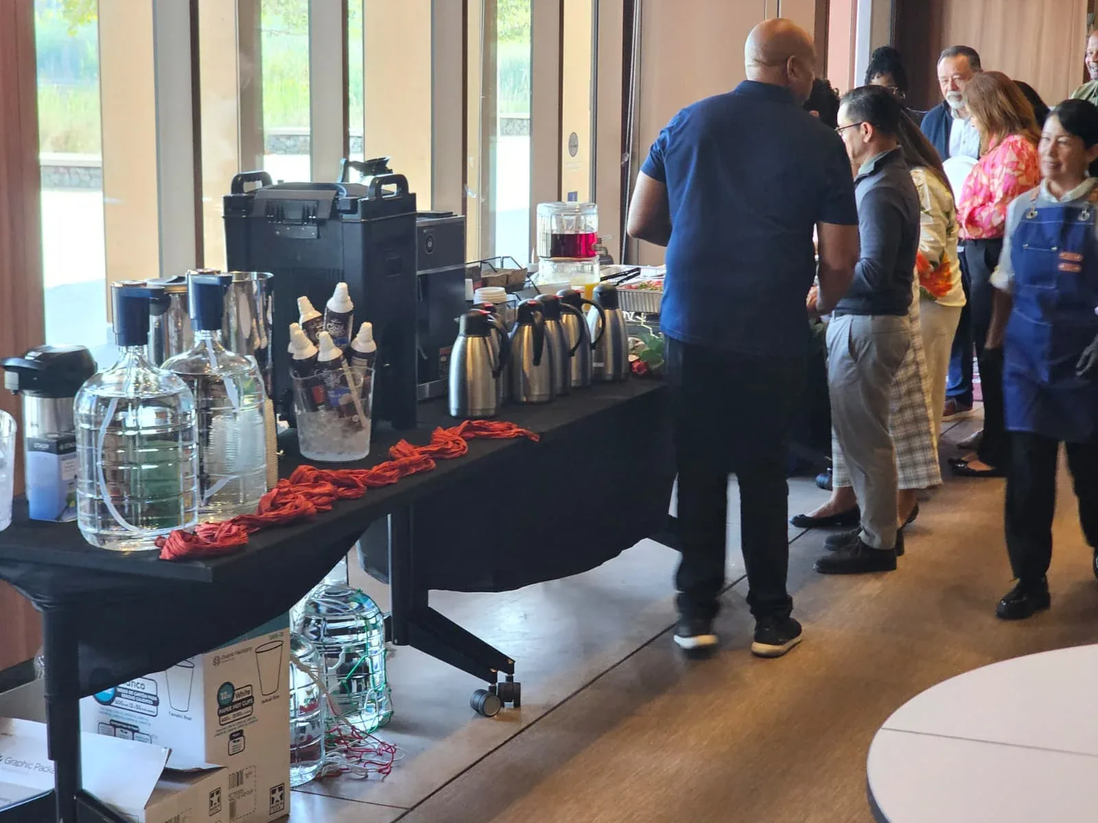 Carthage Kitchen staff serving LA County public defenders at the beverage and breakfast station